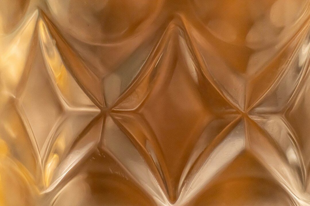 Macro detail of hand carved acetate eyewear frame texture