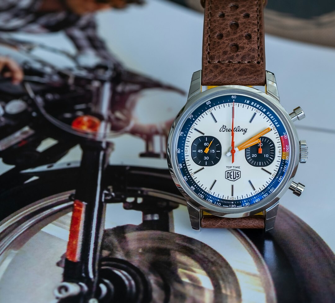 Vintage chronograph wristwatch displayed on aged leather with archival papers