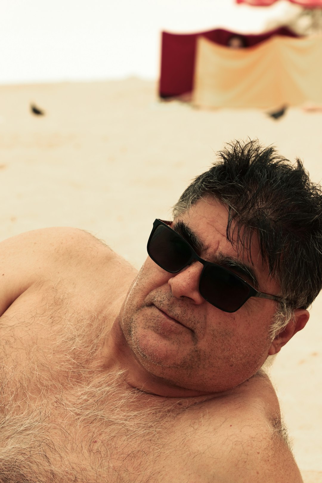 Statement sunglasses on white sand at a Punta del Este beach in summer