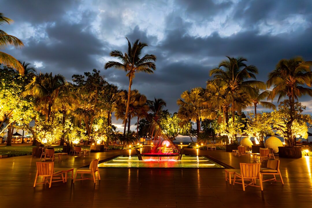 Elegant evening gala scene at sunset on Playa Mansa with guests in formal attire