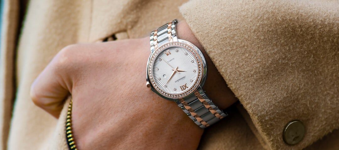 Close up of an elegant woman's wrist wearing a diamond jewelry watch