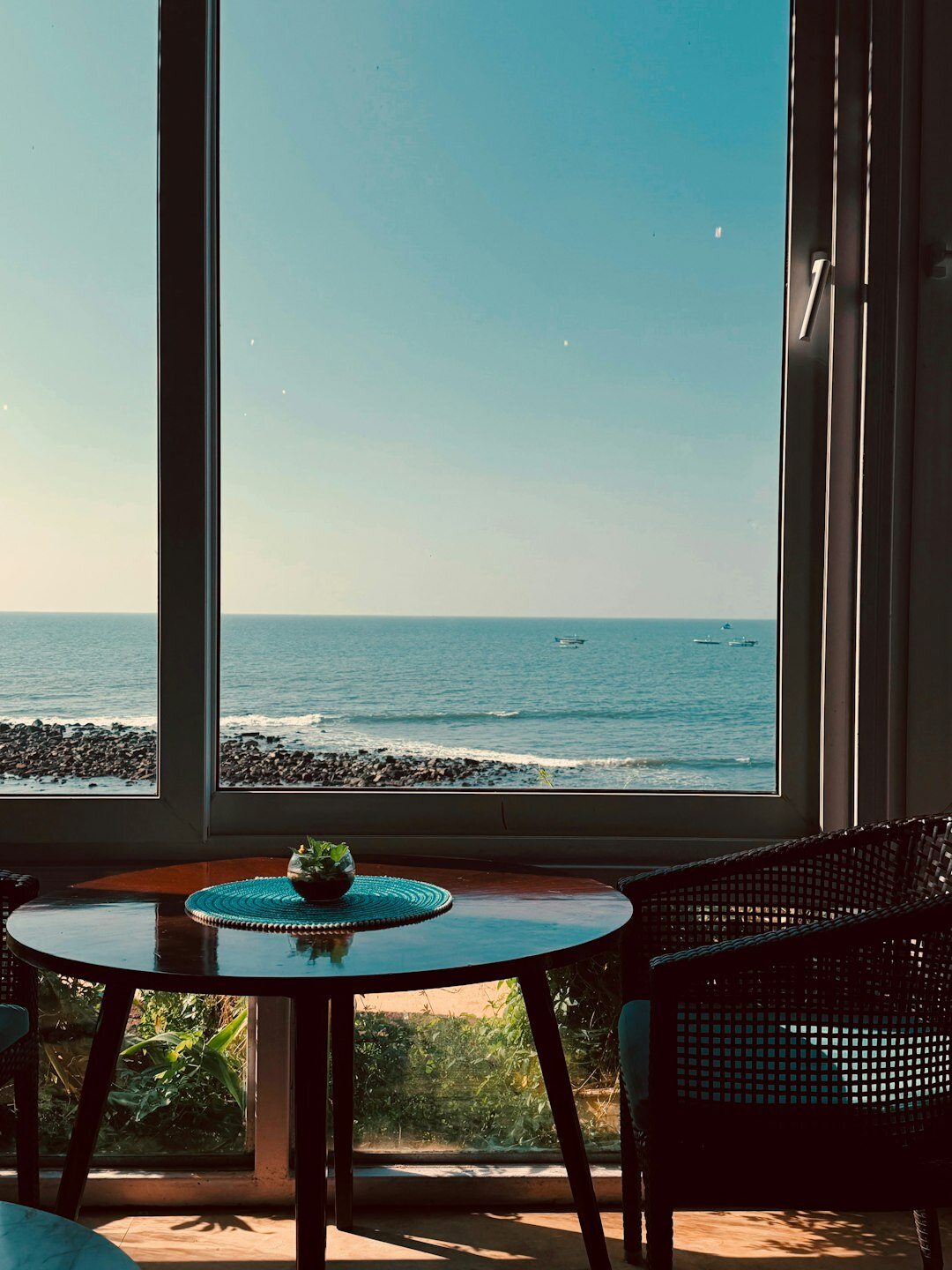 Refined atelier interior with display cases and a view of the Montevideo Rambla
